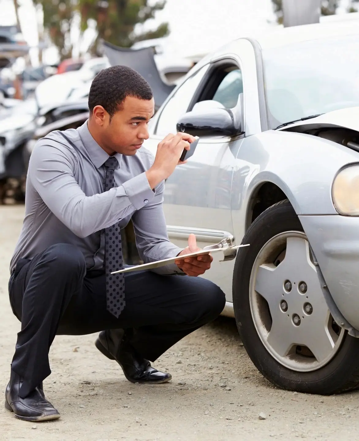 a man inspecting a car